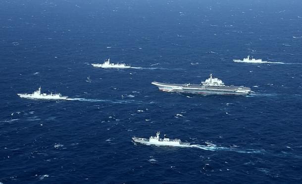 A Chinese navy formation, including the aircraft carrier Liaoning (C), during military drills in the South China Sea. (STR/AFP/GettyImages)